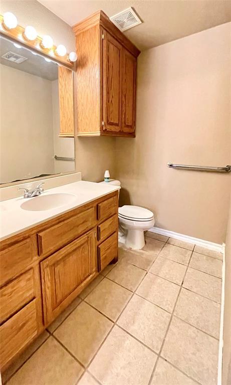 bathroom with tile patterned floors, vanity, and toilet