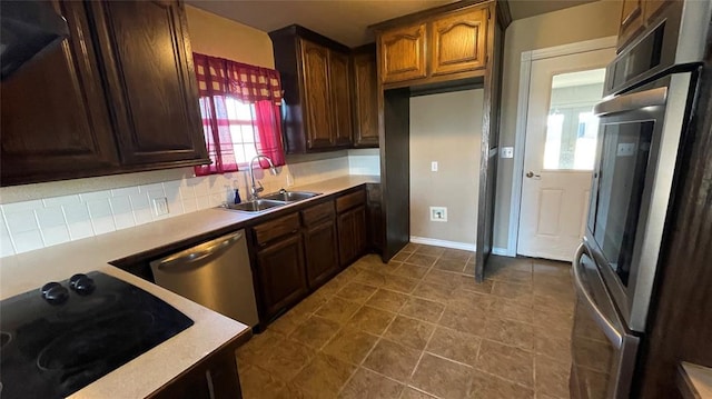 kitchen with fridge, sink, stainless steel dishwasher, black electric cooktop, and tasteful backsplash