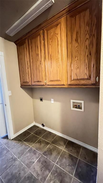 laundry room with electric dryer hookup, hookup for a washing machine, and cabinets