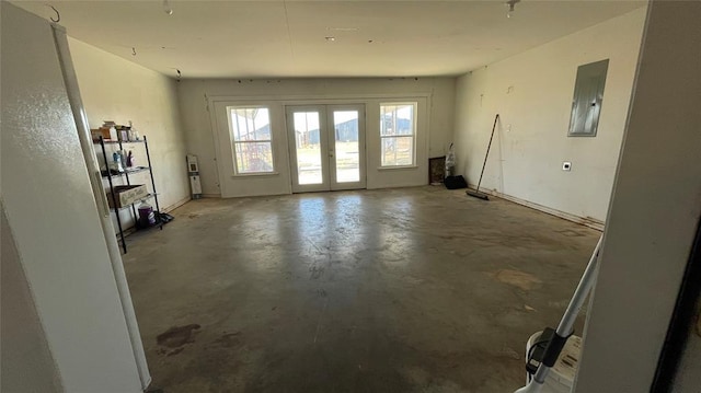 interior space with electric panel and concrete floors