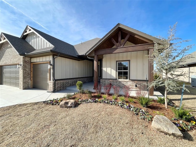 view of front facade with a garage, driveway, board and batten siding, and a porch