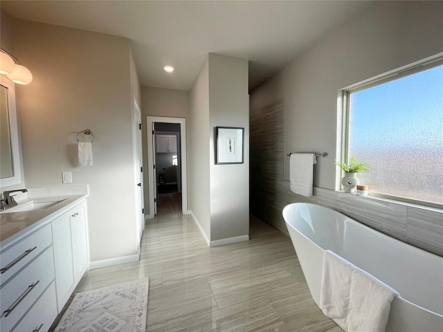 bathroom featuring vanity and a bath