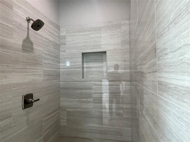 bathroom with tiled shower