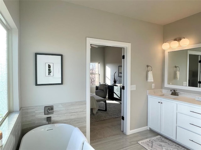 bathroom featuring a bathing tub, vanity, wood-type flooring, and tile walls