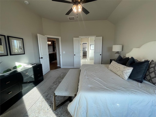 carpeted bedroom with vaulted ceiling and ceiling fan