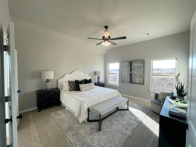 bedroom featuring lofted ceiling, light carpet, visible vents, and baseboards