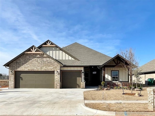 view of front of property with brick siding, a shingled roof, an attached garage, board and batten siding, and driveway