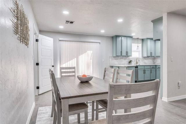 dining room featuring light hardwood / wood-style floors and sink