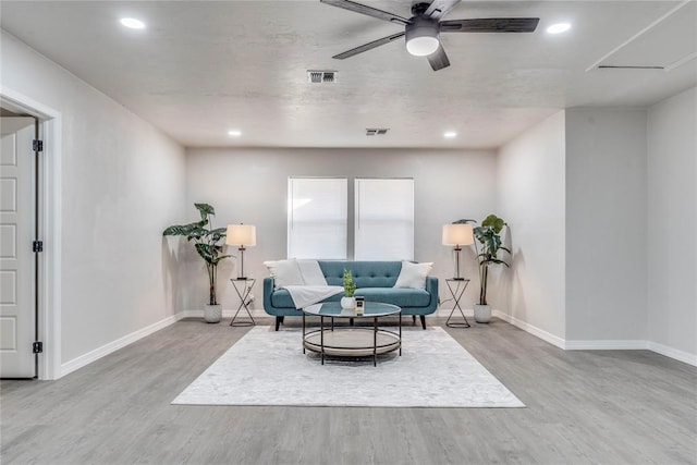 living area featuring ceiling fan and light hardwood / wood-style floors