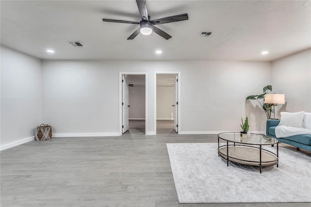 sitting room with ceiling fan and light hardwood / wood-style flooring