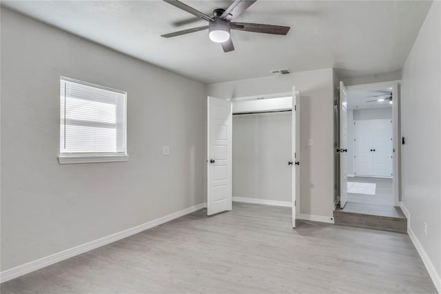 unfurnished bedroom with light wood-type flooring and ceiling fan