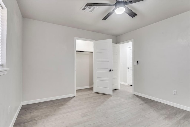 unfurnished bedroom featuring a closet, ceiling fan, and light hardwood / wood-style flooring