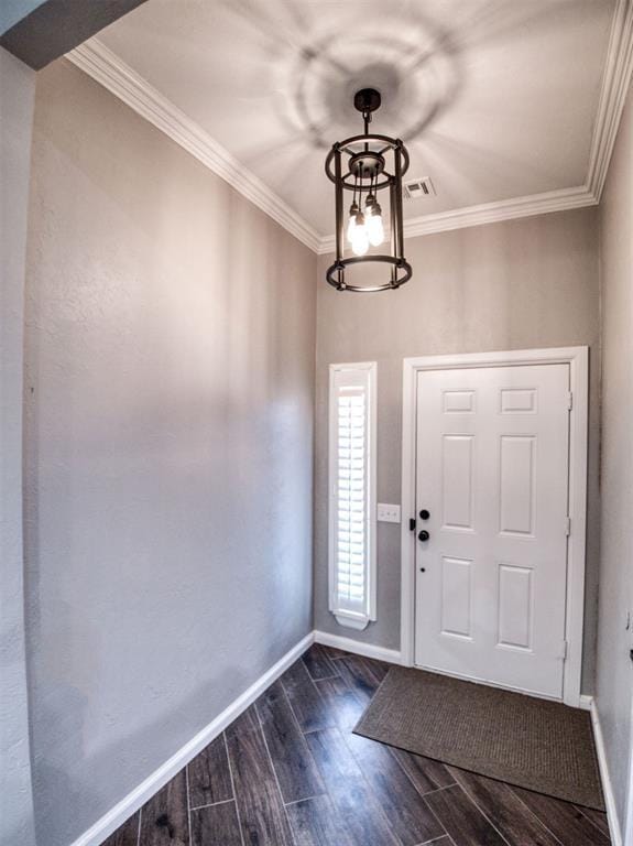 entrance foyer featuring a notable chandelier and ornamental molding