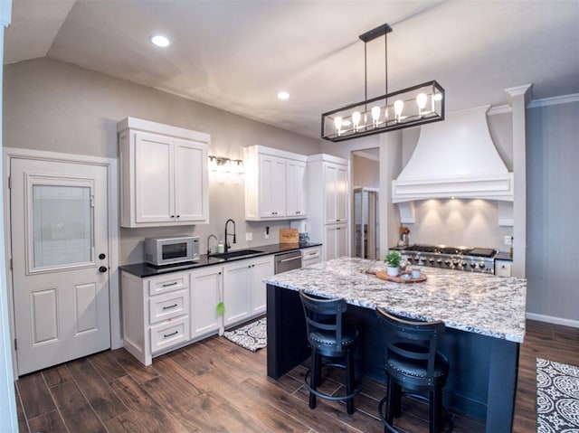 kitchen featuring white cabinetry, sink, hanging light fixtures, dark wood-type flooring, and custom exhaust hood