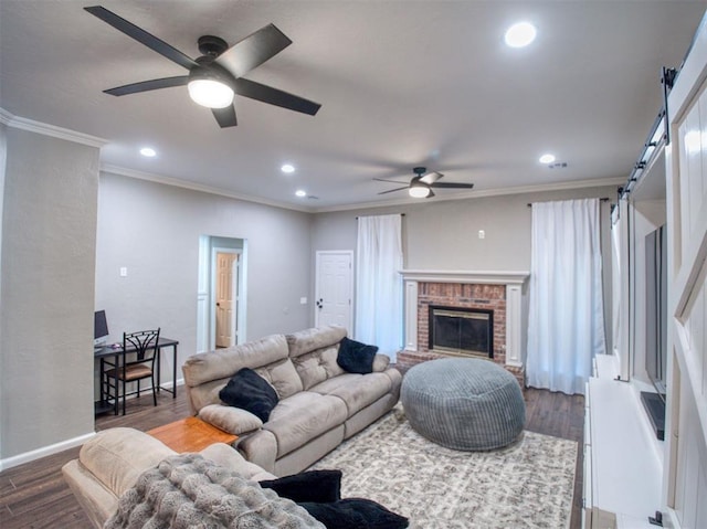 living room with a brick fireplace, ceiling fan, dark hardwood / wood-style floors, and ornamental molding