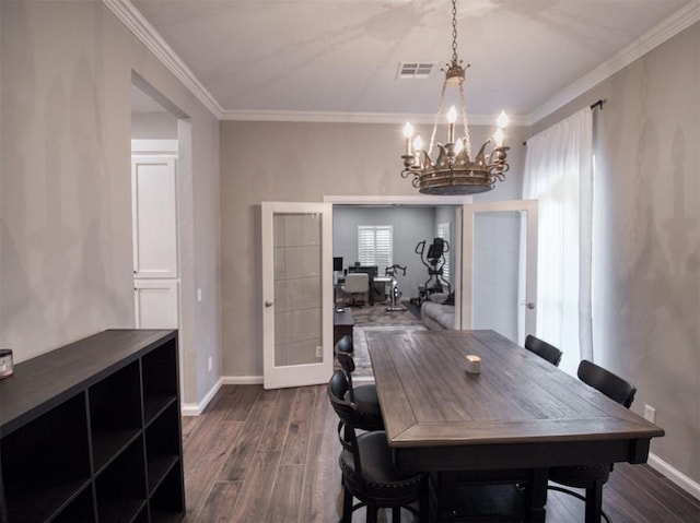 dining space featuring a chandelier, french doors, and ornamental molding