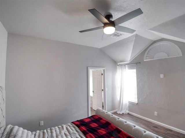 unfurnished bedroom with ceiling fan, vaulted ceiling, and hardwood / wood-style flooring