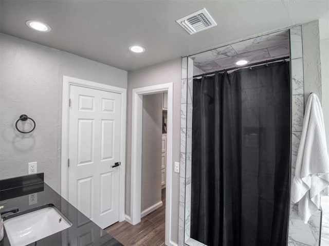 bathroom with a shower with shower curtain and sink