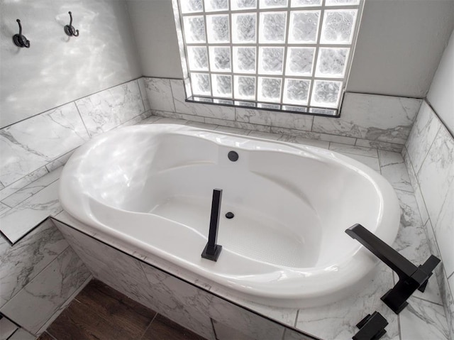 bathroom featuring tiled bath