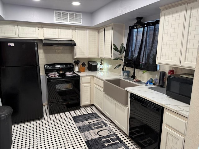 kitchen with visible vents, decorative backsplash, a sink, under cabinet range hood, and black appliances