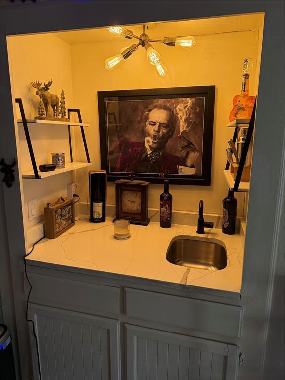 interior details featuring indoor wet bar and a sink