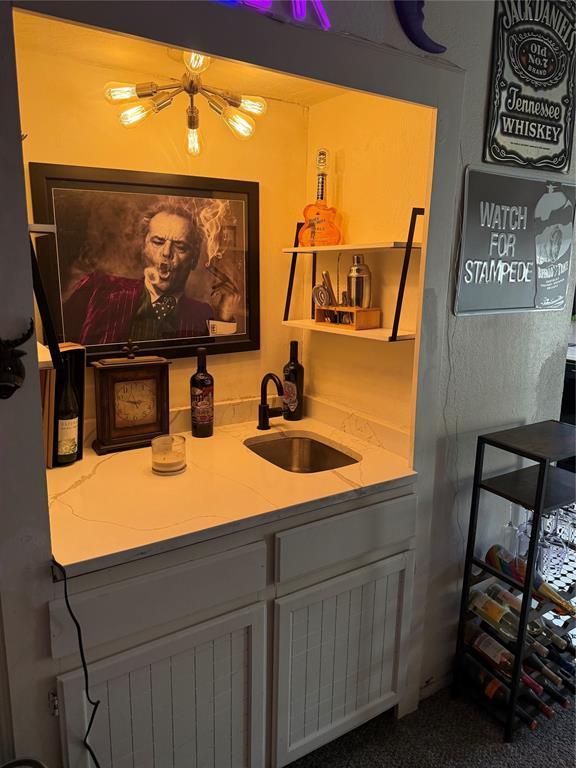 bar with wet bar and a sink