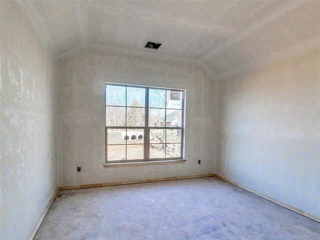 spare room featuring vaulted ceiling