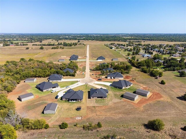 birds eye view of property with a rural view