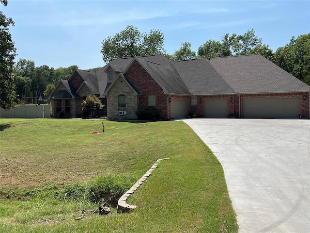 view of front of home with a front yard and a garage