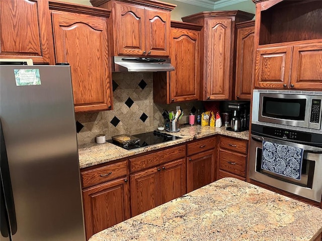 kitchen with decorative backsplash, light stone counters, crown molding, and appliances with stainless steel finishes