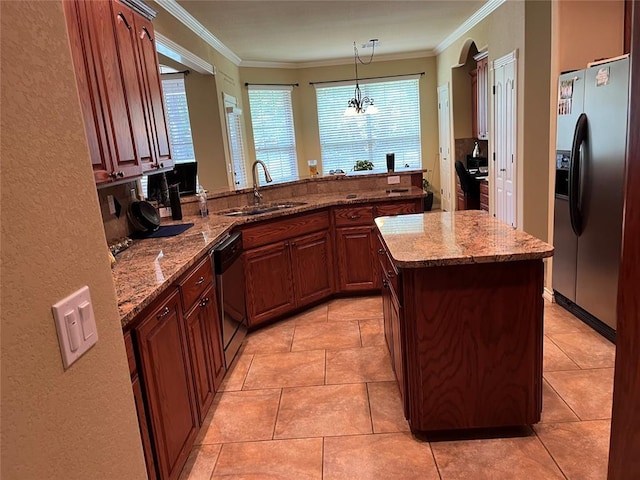 kitchen featuring light stone countertops, sink, stainless steel appliances, an inviting chandelier, and pendant lighting