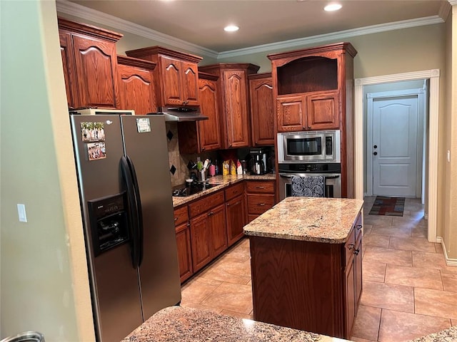 kitchen with appliances with stainless steel finishes, a center island, tasteful backsplash, and ornamental molding