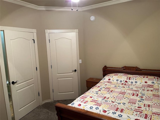 bedroom featuring crown molding and dark colored carpet