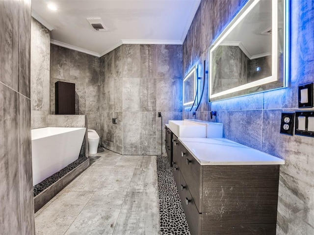 bathroom featuring ornamental molding, vanity, tile walls, tile patterned flooring, and toilet