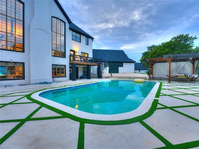 view of swimming pool featuring a pergola and a patio