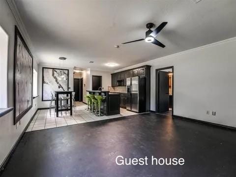 interior space featuring ceiling fan and ornamental molding