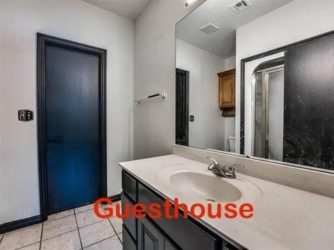 bathroom with tile patterned floors and vanity