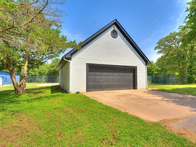 view of side of property featuring a lawn and a garage