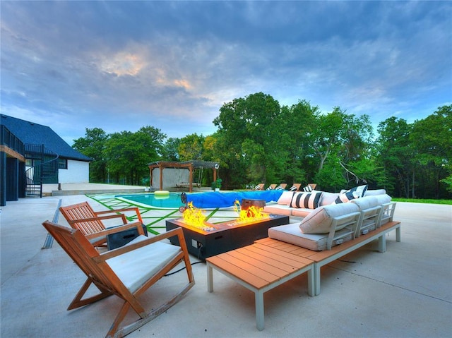 view of patio / terrace with a pergola and an outdoor living space with a fire pit