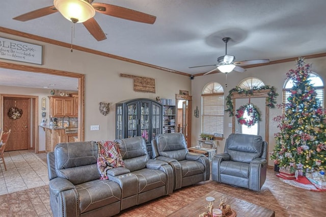 living room with ceiling fan and ornamental molding