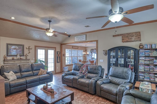 living room with ceiling fan with notable chandelier, light wood-type flooring, lofted ceiling, and ornamental molding