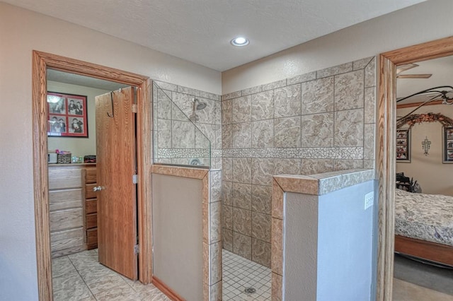 bathroom featuring tile patterned flooring and a tile shower