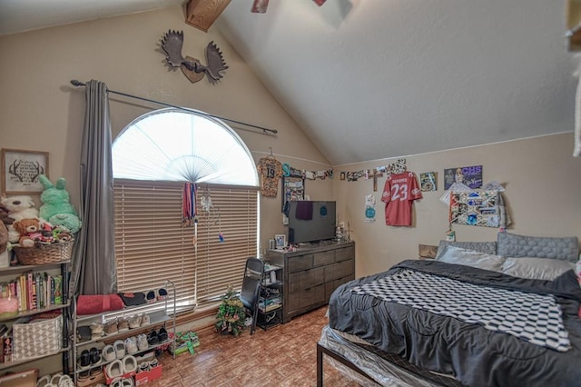 bedroom featuring vaulted ceiling with beams and ceiling fan