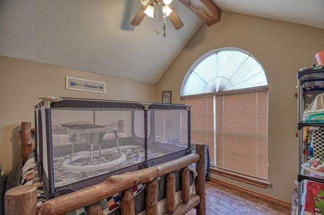 bedroom featuring vaulted ceiling with beams, ceiling fan, and hardwood / wood-style flooring