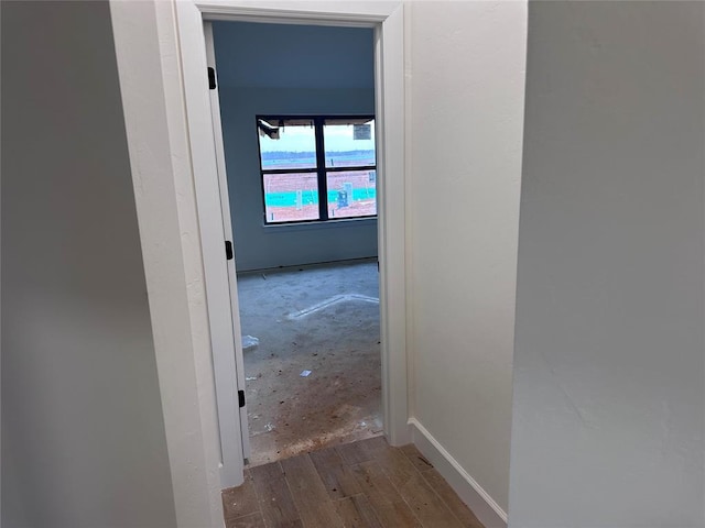 hallway with hardwood / wood-style floors