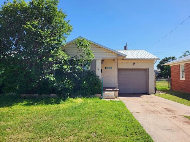 view of front of home with a garage and a front lawn