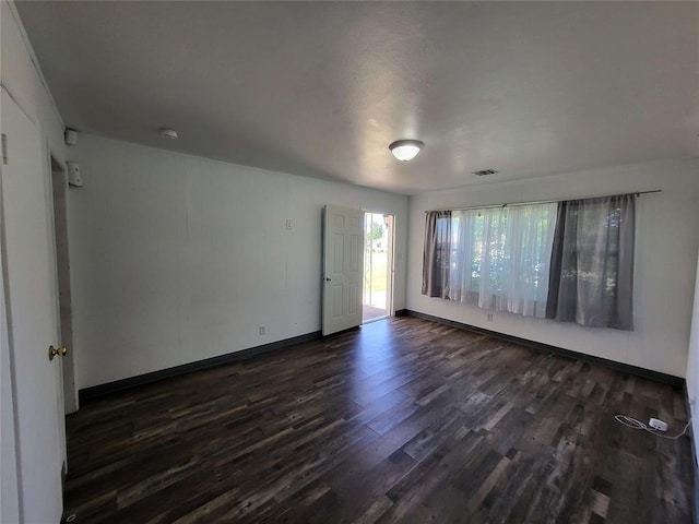 unfurnished room with dark hardwood / wood-style floors