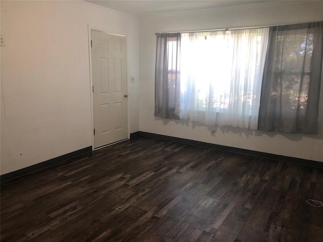 unfurnished room with dark hardwood / wood-style floors