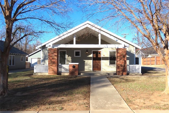 bungalow-style house with a front lawn and a porch