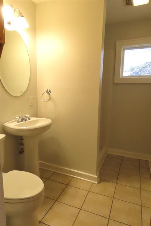 bathroom with sink, tile patterned flooring, and toilet